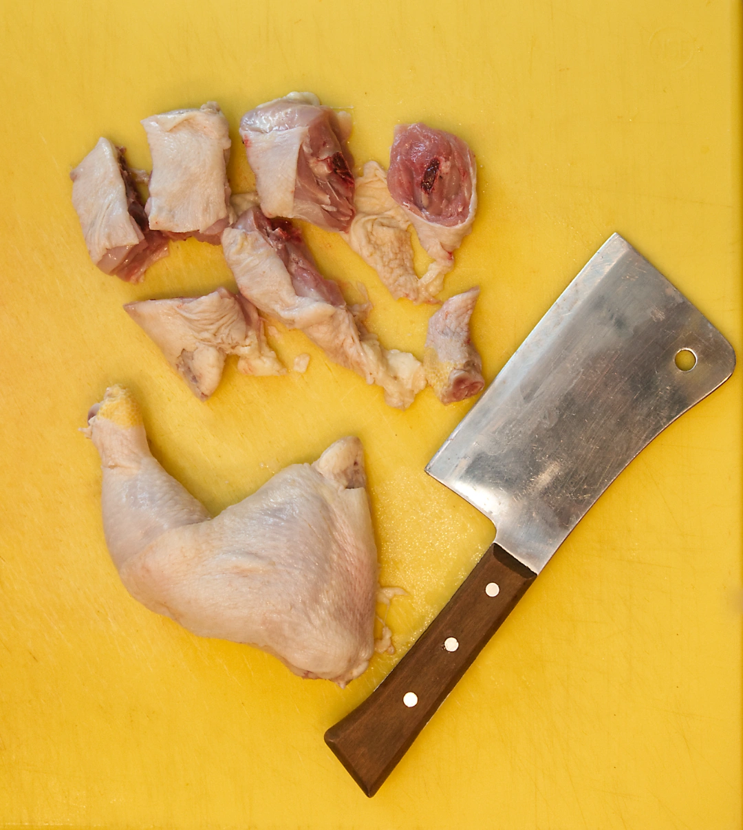 Chicken leg quarters cut into pieces for meat grinder